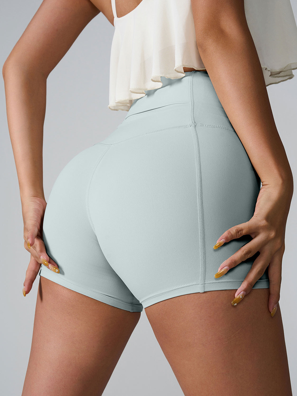 Light Green active shorts with sculpted pocket detail and seamless stitching.