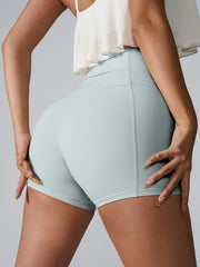 Light Green active shorts with sculpted pocket detail and seamless stitching.