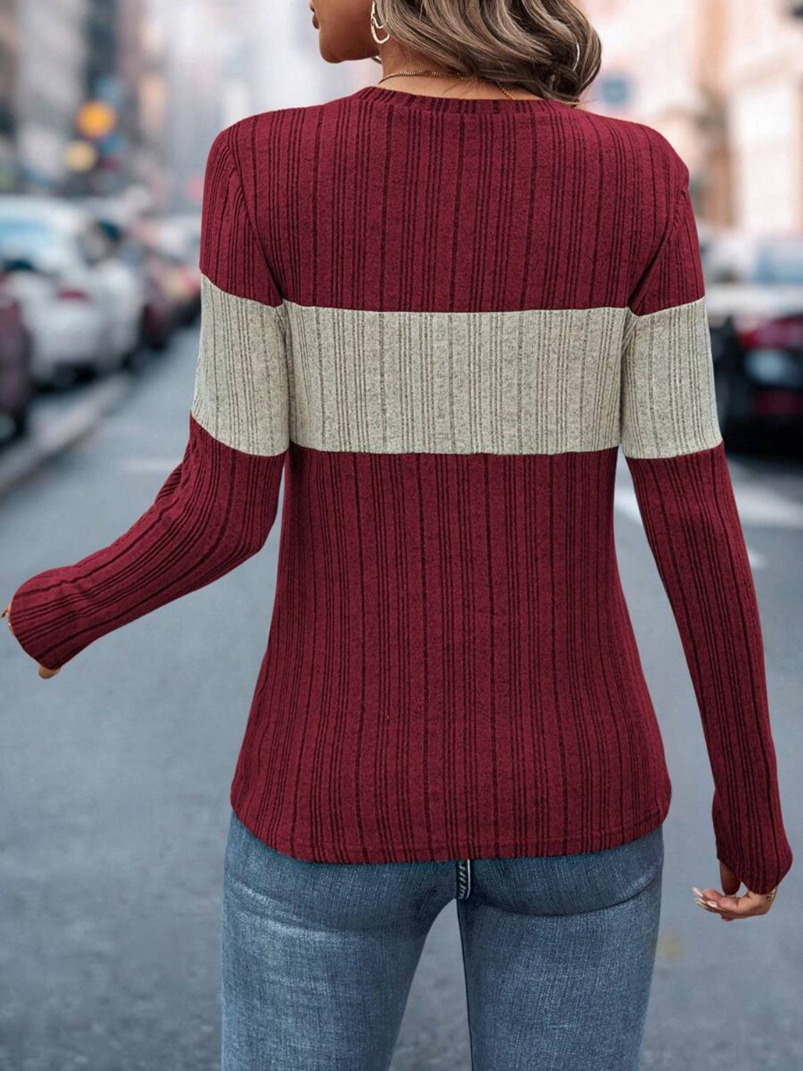 Ribbed crewneck sweater in burgundy with a cream colorblock stripe.