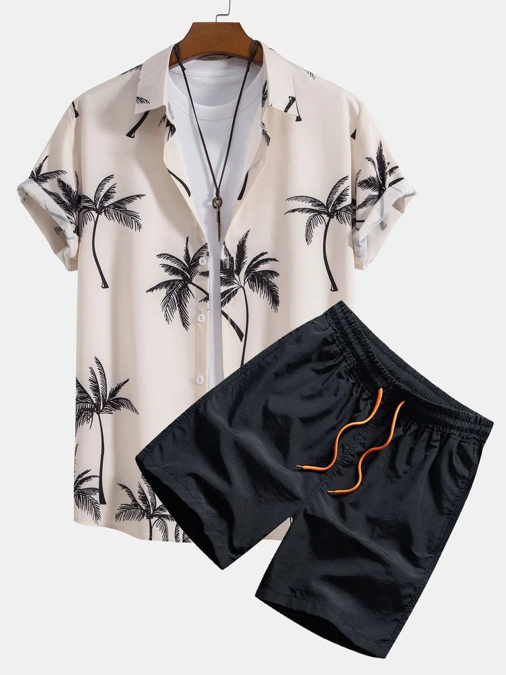 Men's tropical print short sleeve button-down shirt in pale blush with black palm trees and black drawstring shorts.