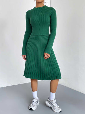 Green ribbed knit fit-and-flare dress with long sleeves and a pleated skirt.