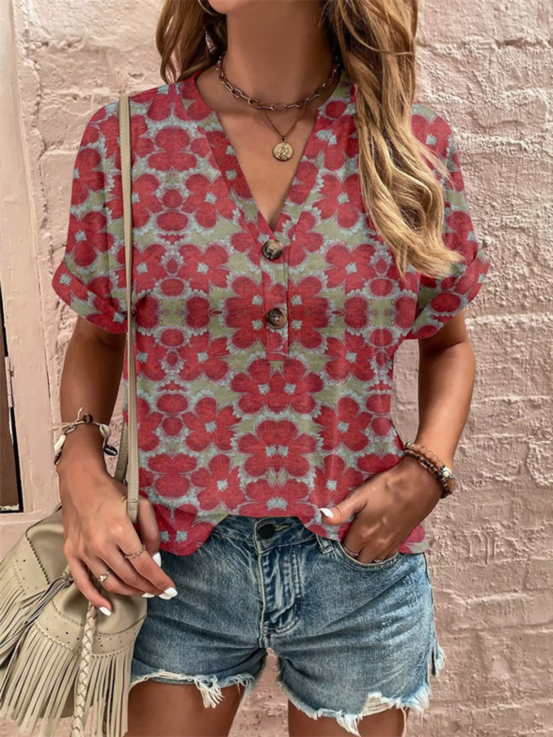 Americana Henley top with red floral print, V-neck, short sleeves, and button detail.