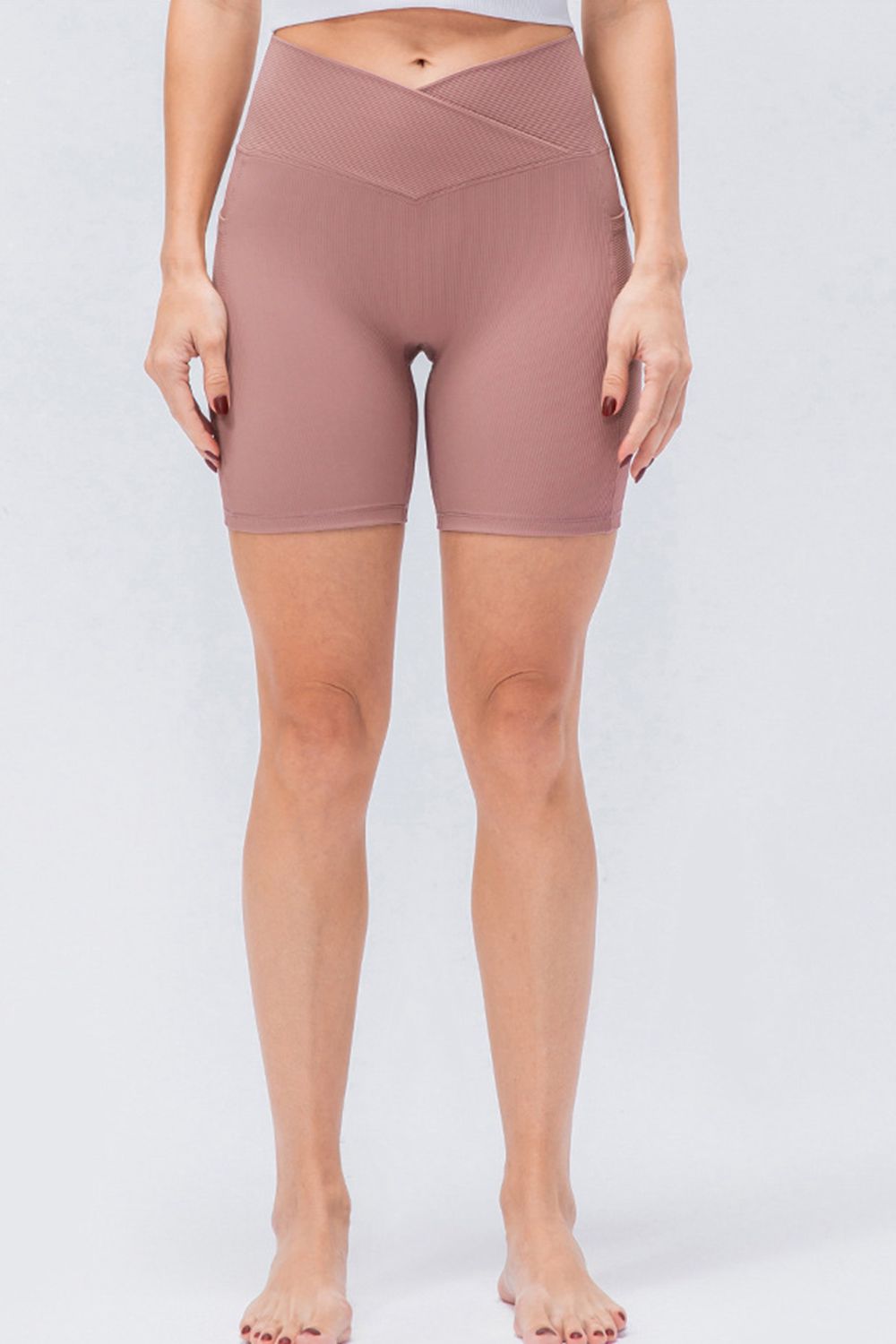 Cross-waist ribbed bike shorts in Dusty Pink with a textured waistband detail.