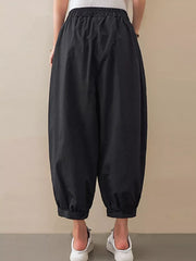 Black relaxed fit harem joggers with elastic waist and cuffed ankles.