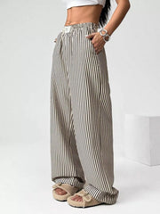 Navy striped high-waisted wide-leg pants with drawstring detail and pockets.