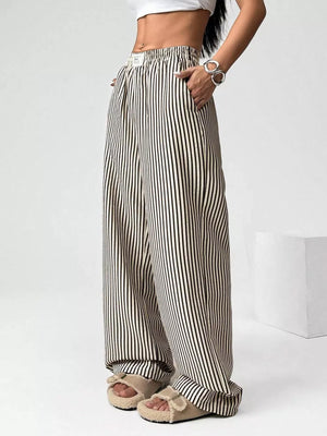 Navy striped high-waisted wide-leg pants with drawstring detail and pockets.