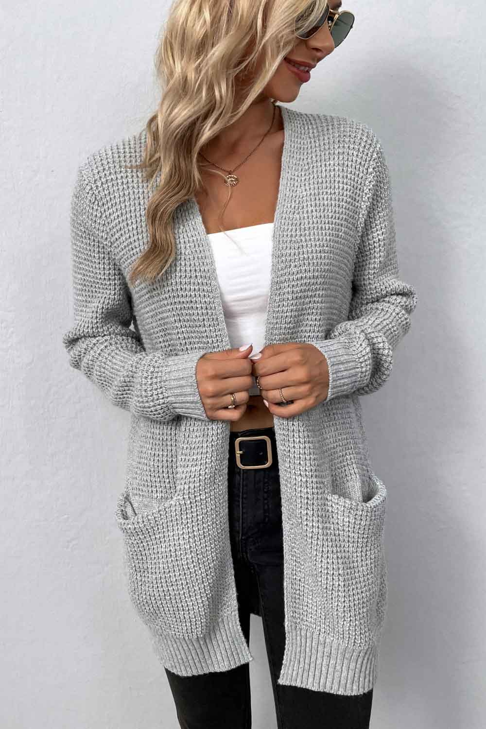 Light gray waffle knit longline cardigan with pockets and open front.
