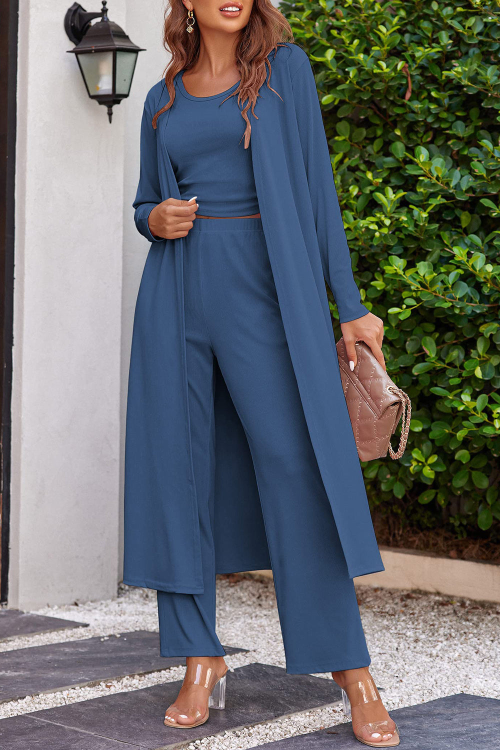 Ribbed knit duster and lounge set in light blue, featuring a crop top, wide leg pants, and long duster cardigan.