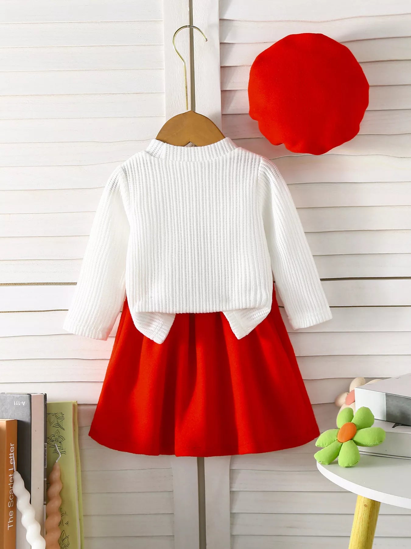 Baby girl red skirt and white knit cardigan set with floral applique detail.