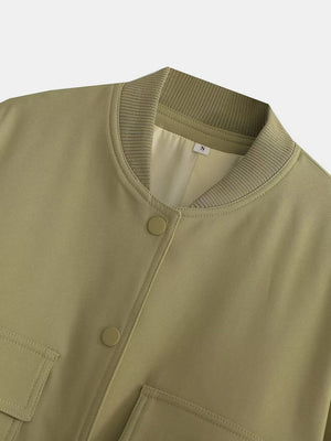 Boxy bomber jacket in moss green with ribbed collar, snap buttons, and flap pockets.