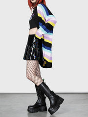 Rainbow stripe oversized knit cardigan with black, yellow, blue, and purple stripes.