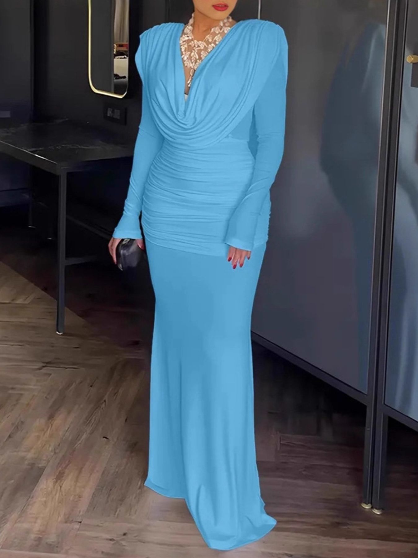 Blue ruched long-sleeve maxi dress with cowl neck and fitted skirt.