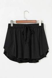 Black flared skort with tie waist and elastic waistband.