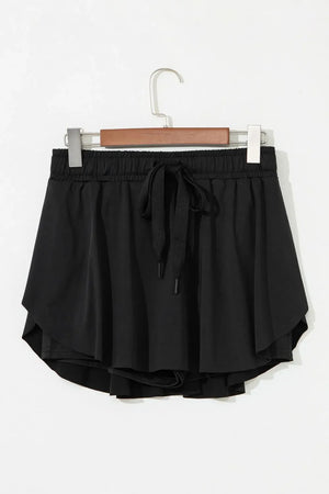Black flared skort with tie waist and elastic waistband.