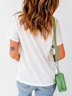 White short sleeve t-shirt with rolled cuffs and an eye tattoo on the arm.
