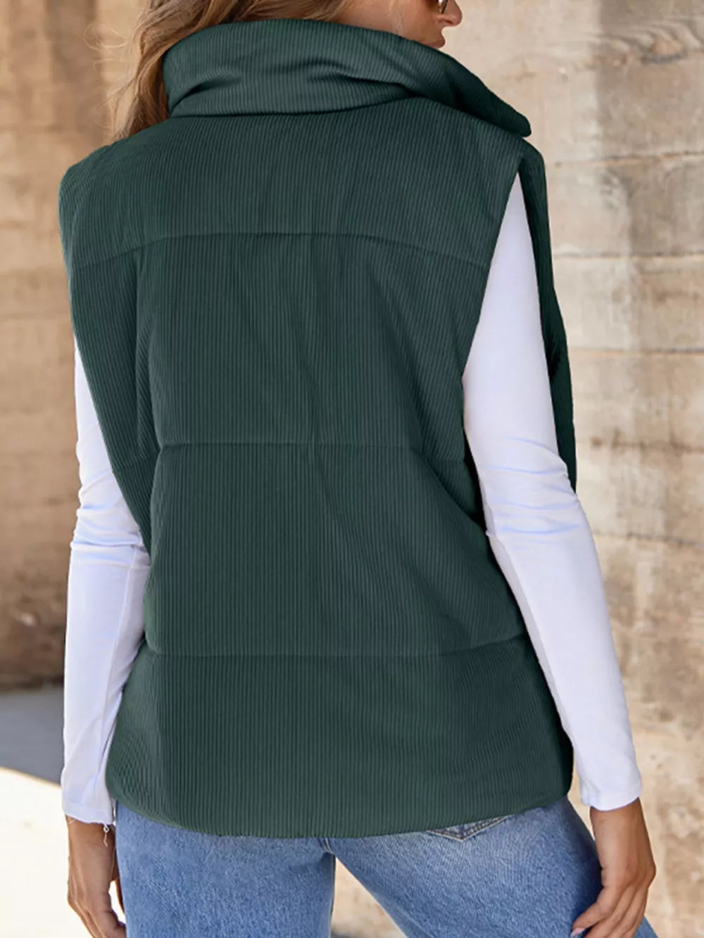 Green corduroy zip-up vest coat with high collar and ribbed texture.