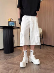 Relaxed white cargo cropped pants with large side pockets and a wide leg.