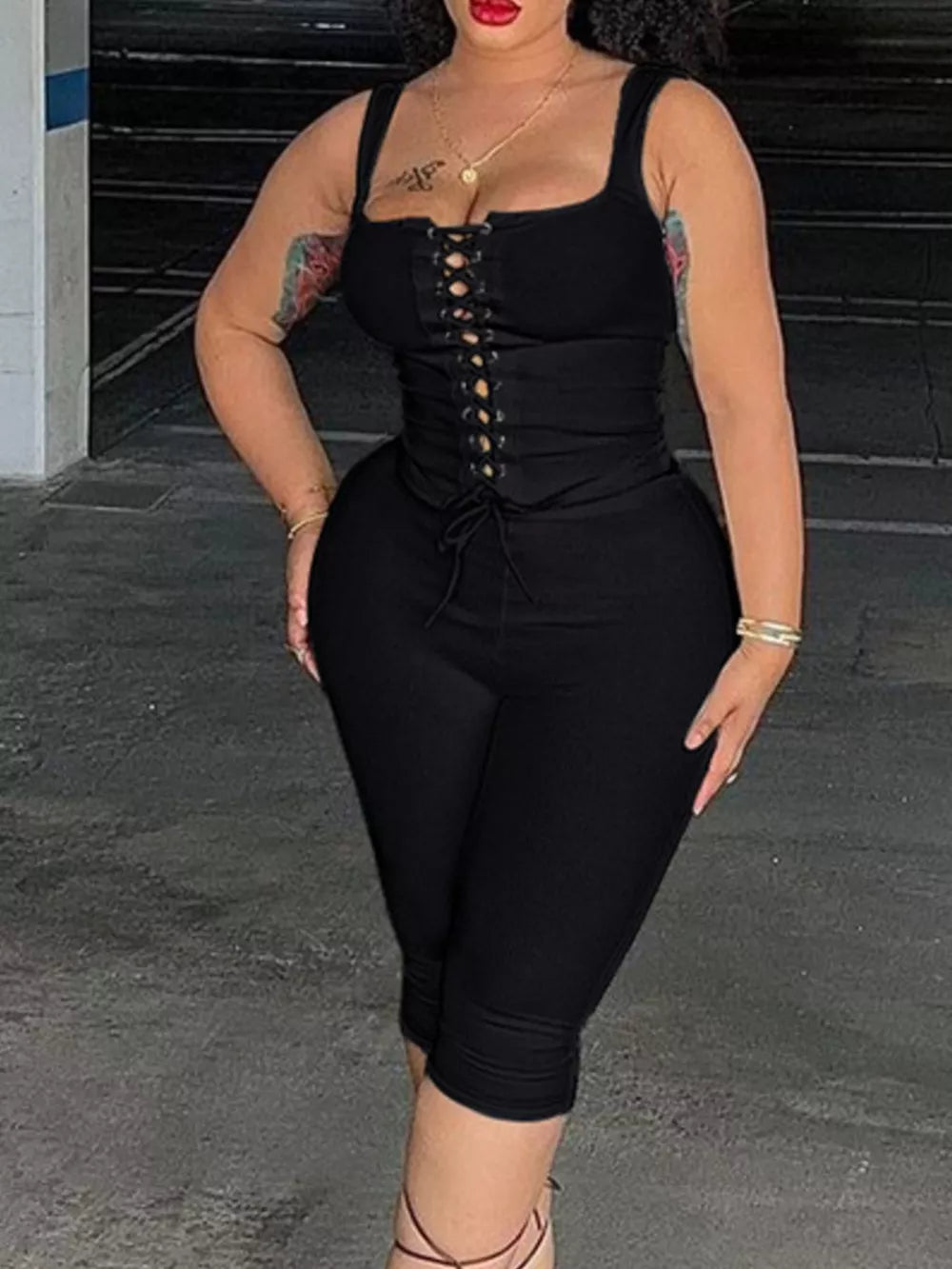 Black ribbed lace-up tank top and capri pants ensemble with square neckline.