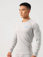 Gray performance raglan sleeve tee with blue logo, crew neck, long sleeves.