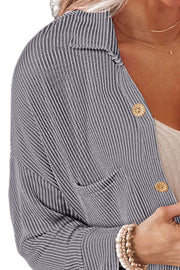 Gray striped overshirt with oversized fit, button front, and chest pocket.