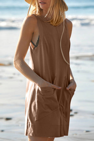 Brown linen romper with pockets and relaxed fit.