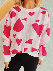 Heart motif knit sweater in white with hot pink hearts, crewneck, long sleeves.