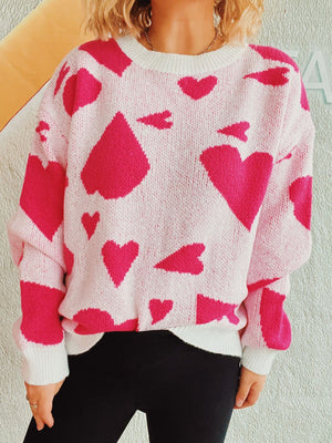 Heart motif knit sweater in white with hot pink hearts, crewneck, long sleeves.