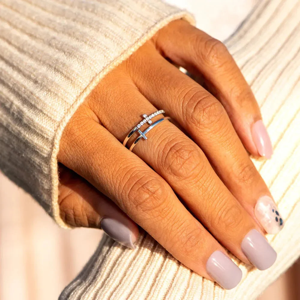 Double cross diamond band ring in silver with two stacked bands and cross details.