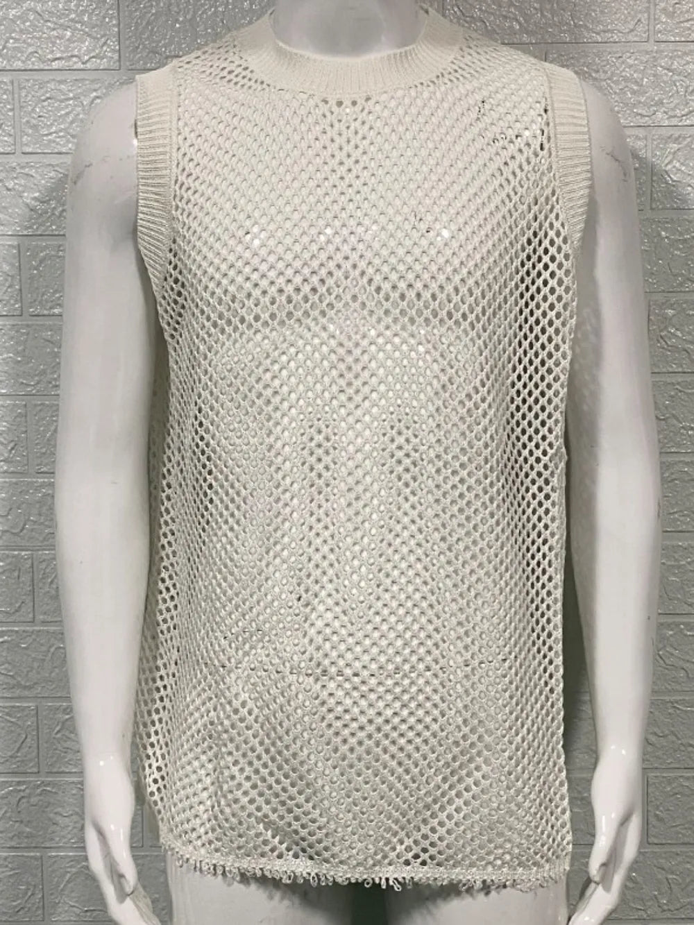 Ivory open-knit tank top with ribbed trim and a mesh pattern.