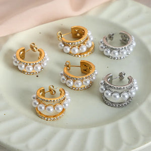 Pearl and pave double hoop earrings in gold and silver with multiple rows of pearls and rhinestones.