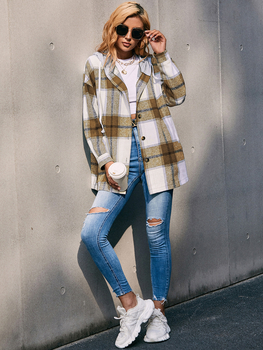 Oversized plaid shacket with hood in brown and white, featuring a casual cut and button front.