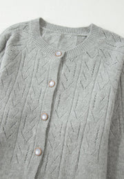 Gray lace-effect knit button-down cardigan with pearl buttons and a crew neck.