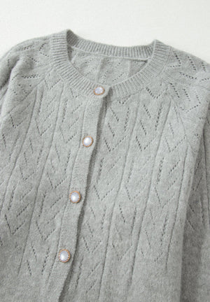 Gray lace-effect knit button-down cardigan with pearl buttons and a crew neck.
