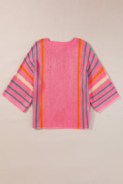 Pink knit pullover sweater with colorblock stripes on sleeves and vertical stripes.