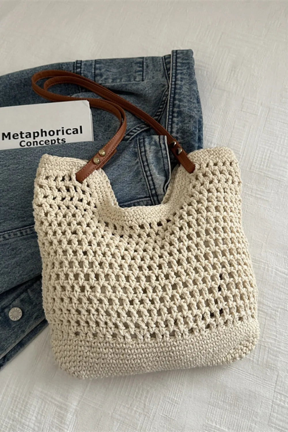 Ivory crochet weave shoulder bag with brown leather straps.