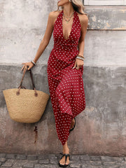 Burgundy polka dot halter maxi dress with a deep V-neckline and flowing skirt.