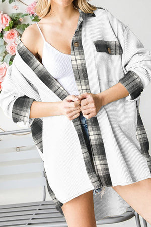 Waffle knit overshirt in white with black plaid trim and button front.