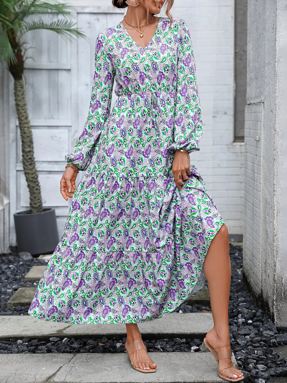 Vibrant paisley print maxi dress with V-neck, balloon sleeves, tiered skirt, and drawstring waist.