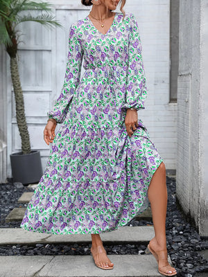 Vibrant paisley print maxi dress with V-neck, balloon sleeves, tiered skirt, and drawstring waist.