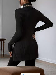 Black ribbed turtleneck t-shirt with long sleeves and side slit, worn with leggings.