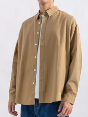 Camel long sleeve button-up shirt with white buttons, layered over a white tee.