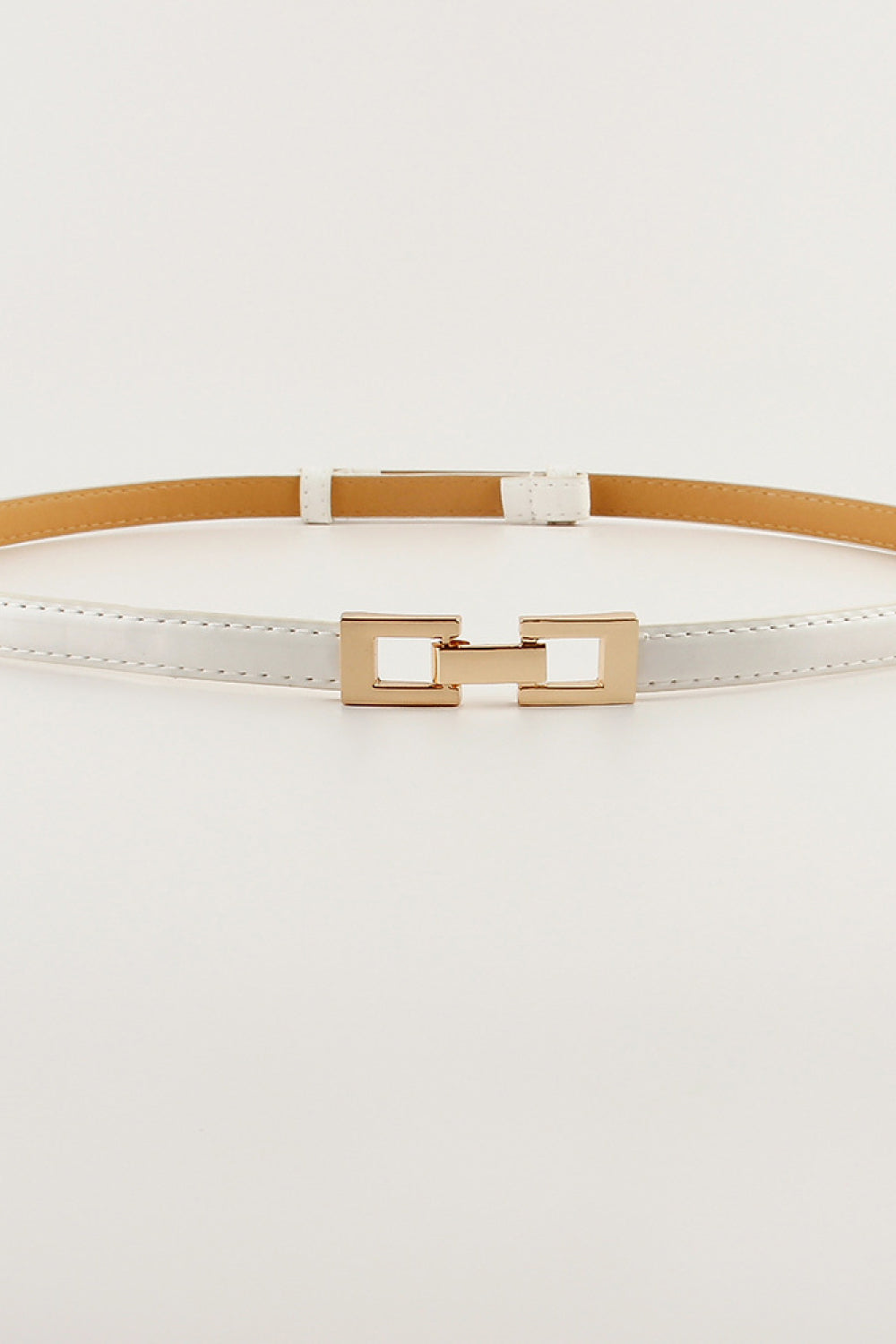White leather belt with a gold geometric buckle