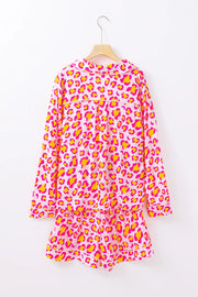 Pink leopard print satin pajama set with collared top and shorts.