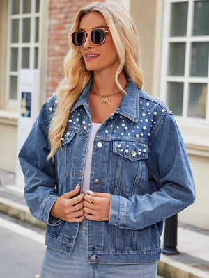Denim jacket with pearl embellishments on shoulders and pockets.