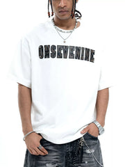 Oversized white cotton t-shirt with black textured logo graphic on chest.