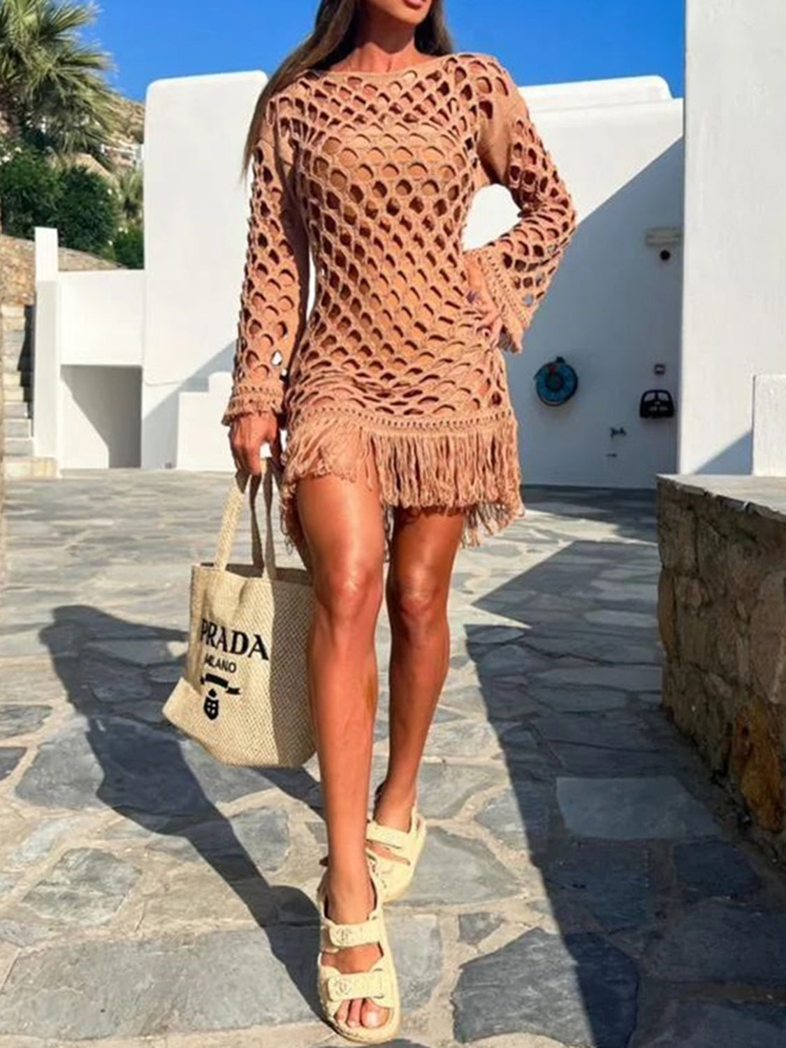 Caramel open-knit cover-up with fringe hem and bell sleeves.