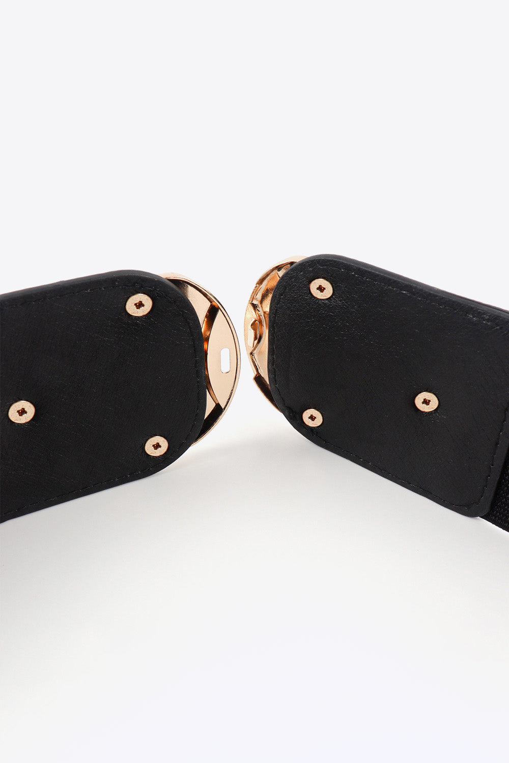 Black elastic belt with double gold buckles and gold stud details.