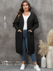 Black oversized knit duster cardigan with patch pockets and ribbed cuffs.