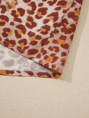 Smocked ruffled print blouse with animal print detail.