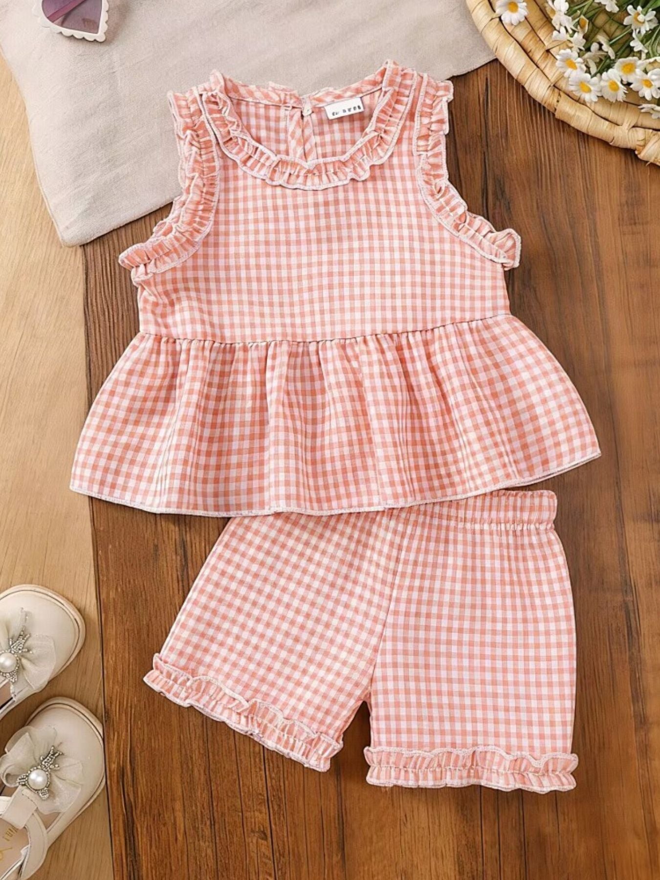 Children's blush pink gingham ruffle two-piece set, cotton, sleeveless peplum top and shorts.